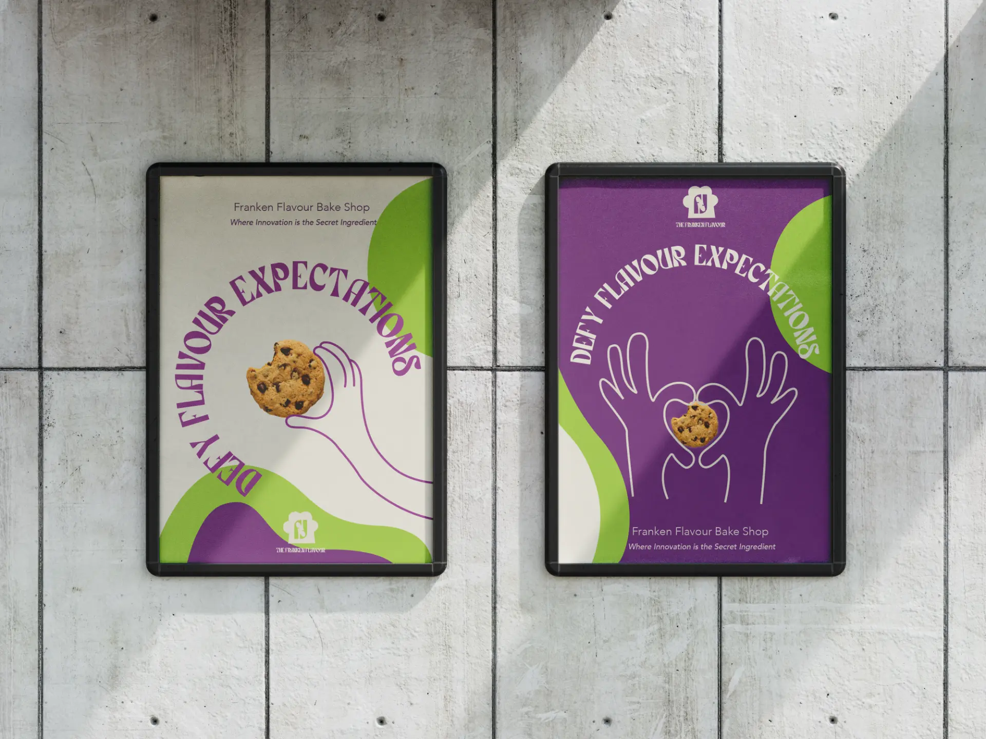 Two framed Franken Flavour posters on a concrete wall with purple, green and cream artwork