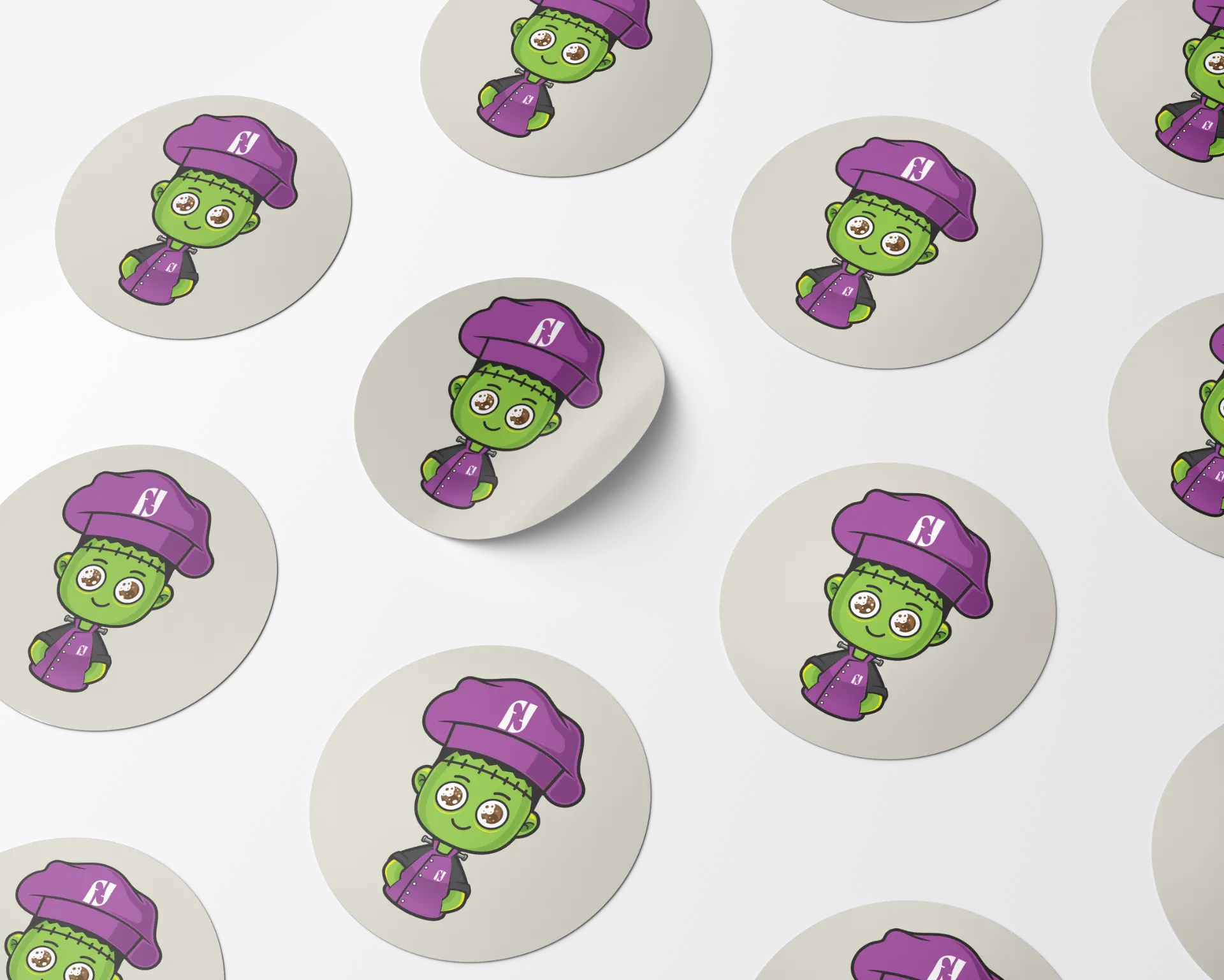 Round Franken Flavour mascot stickers scattered on a dark background
