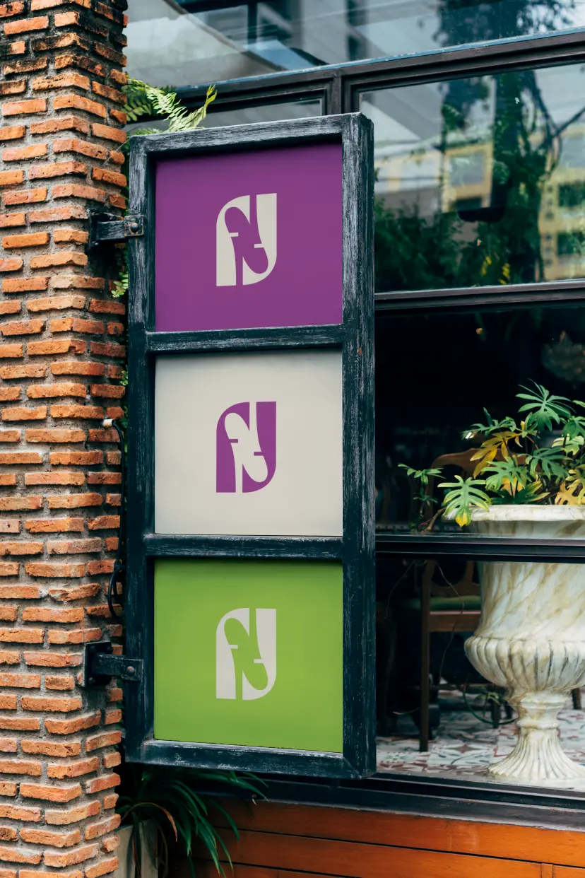 Three-panel Franken Flavour storefront sign with logo in purple, cream and green